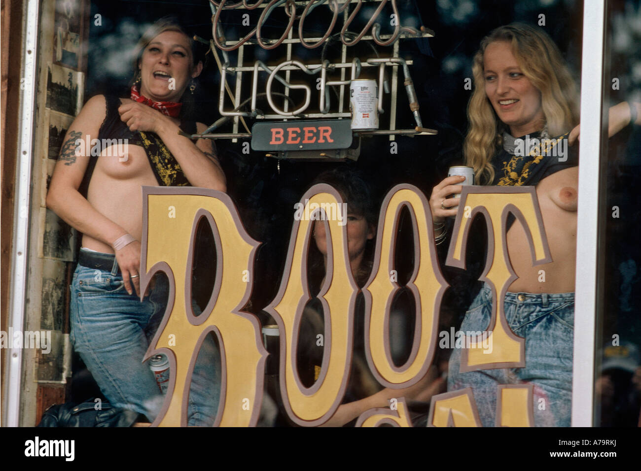 Women in a bar flashing breasts during Bike Week in Daytona Beach Florida USA Stock Photo