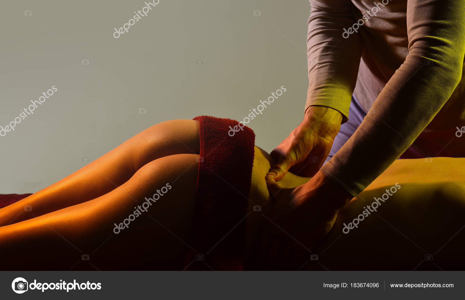 Sexy massage young man hands making massage for girl naked woman lay in bed only in