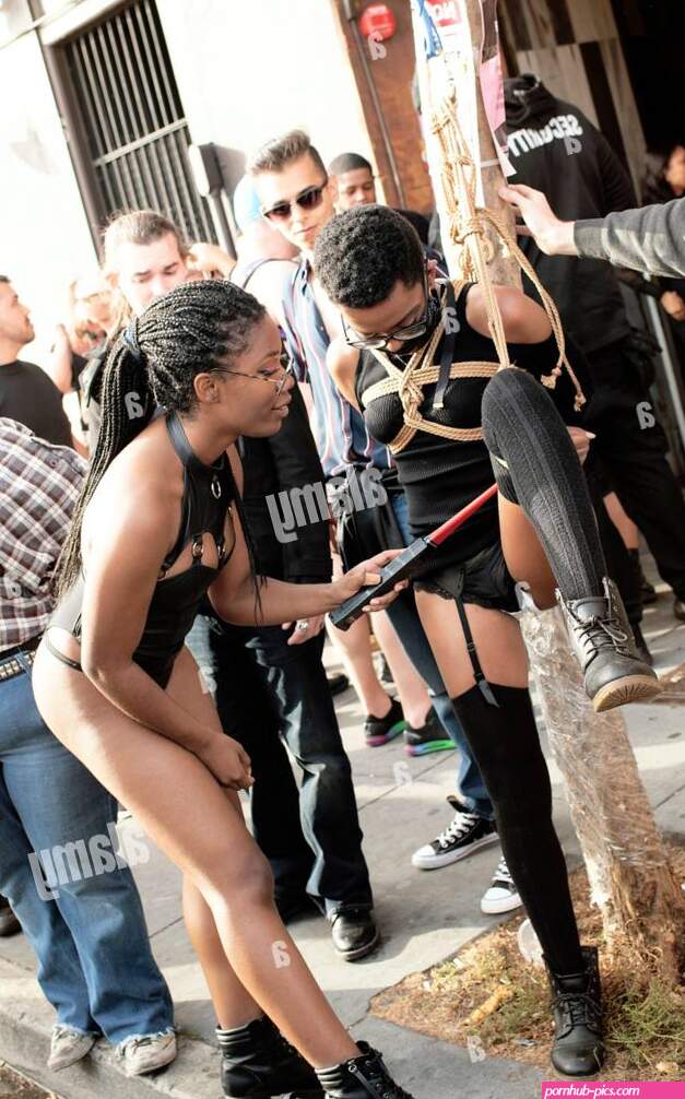 BDSM female electro sex bondage fetish play with electric shock wand. Folsom Street Fair the worlds biggest leather and fetish event. San Francisco Stock Photo