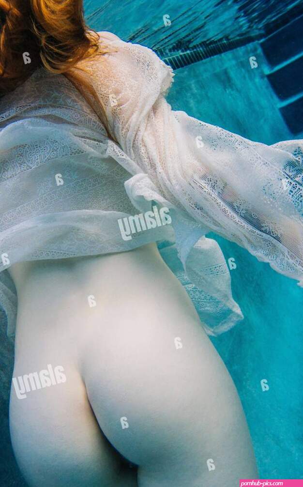 Young woman underwater nude buttocks rear view Stock Photo