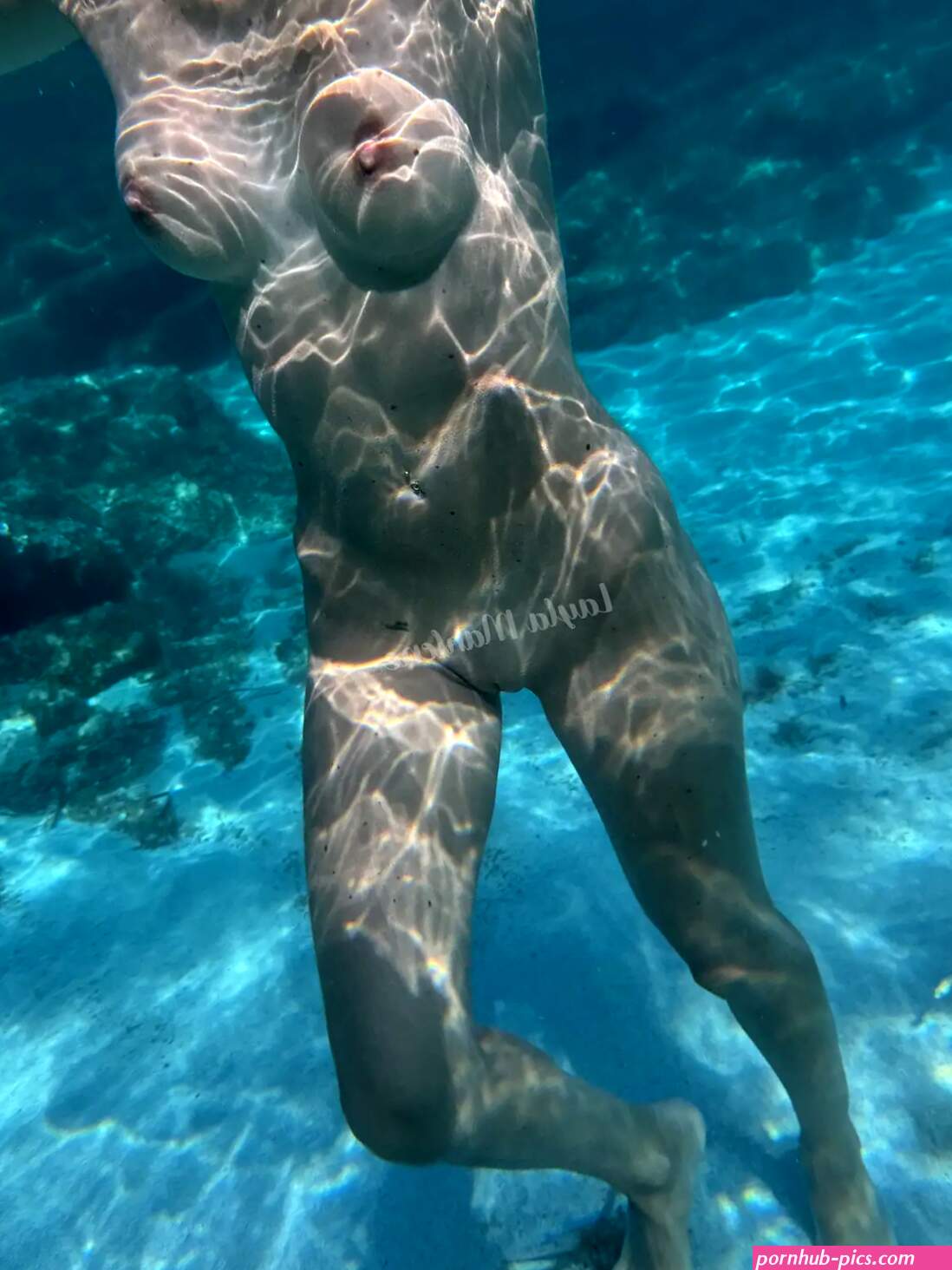 Nude underwater in a crystal-clear sea