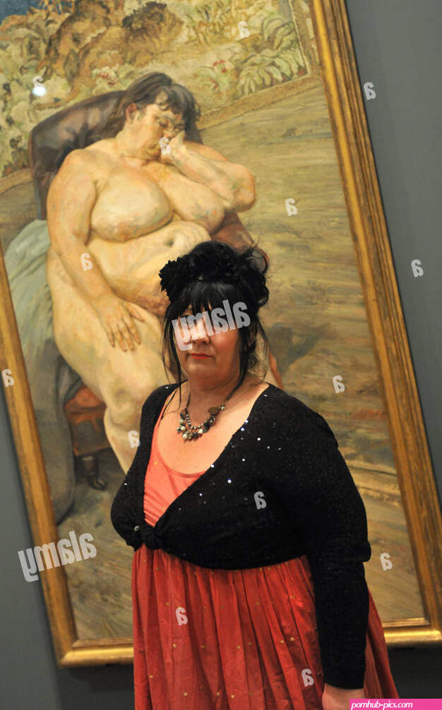 Model Sue Tilley poses in front of a painting depicting her Sleeping by the Lion Carpet Lucian Freud: Portraits