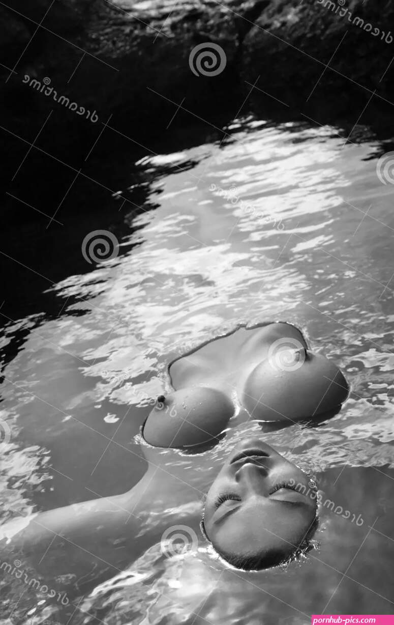 Nude Woman Floating in Water. Stock Photo