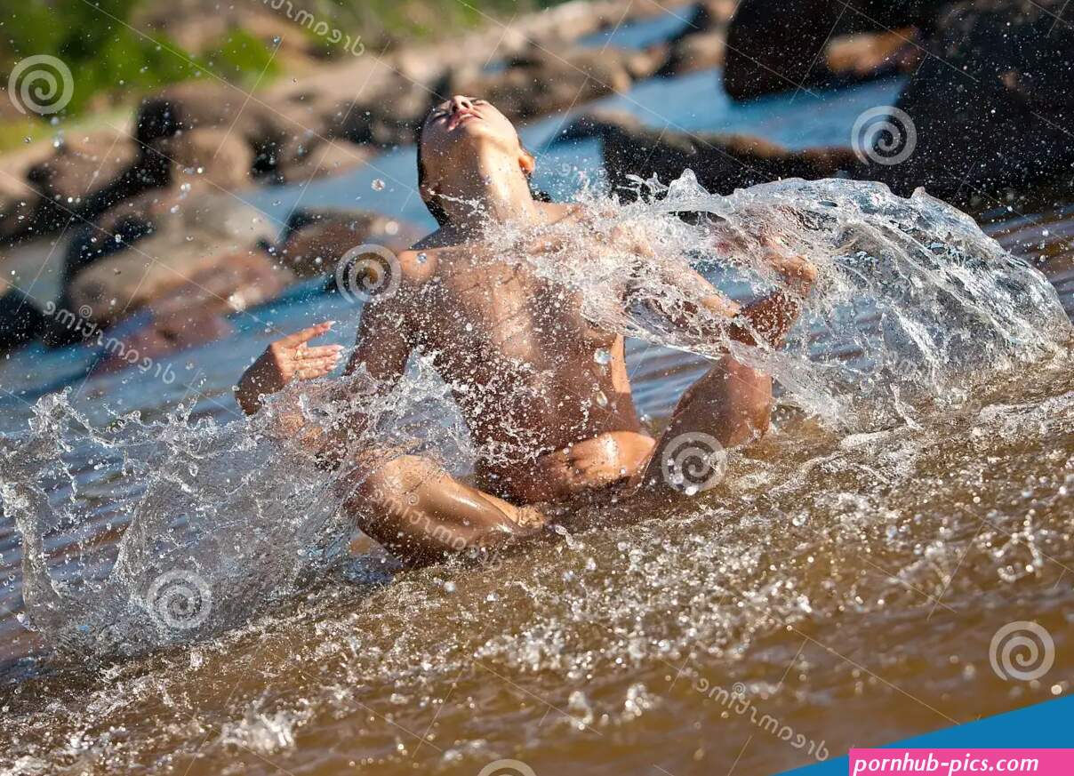 Nude Woman Playing with a Water Splashes Stock Photo