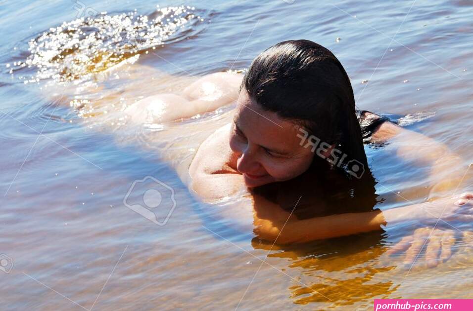 Nude Woman Is Swimming At The Shallow River She Is Lying In The Transparent Water And Smiling Stock Photo Picture and Royalty Free Image. Image 20620274.