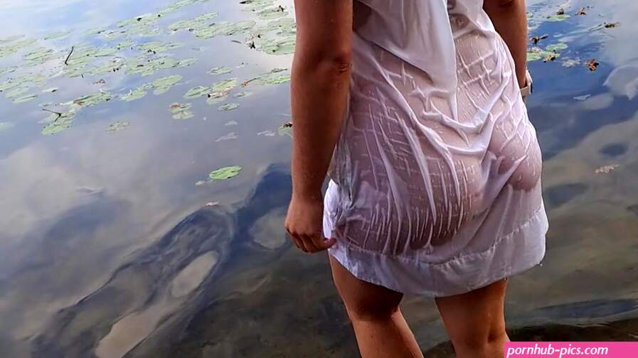 Tender girl. Nymph walks in a wet transparent shirt