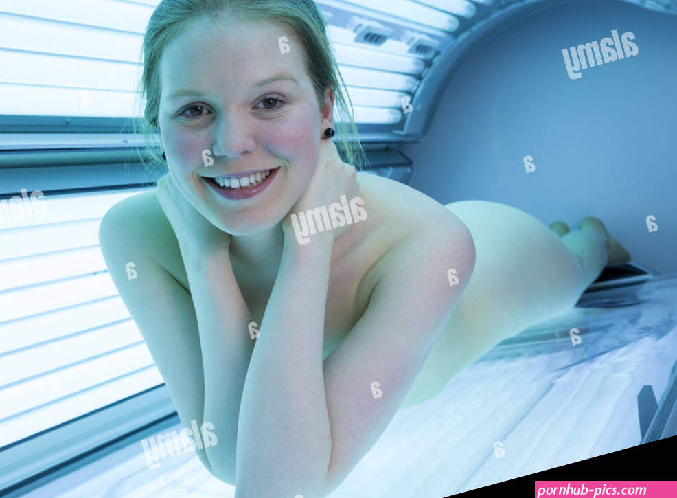 naked woman relaxing on tanning bed in solarium Stock Photo