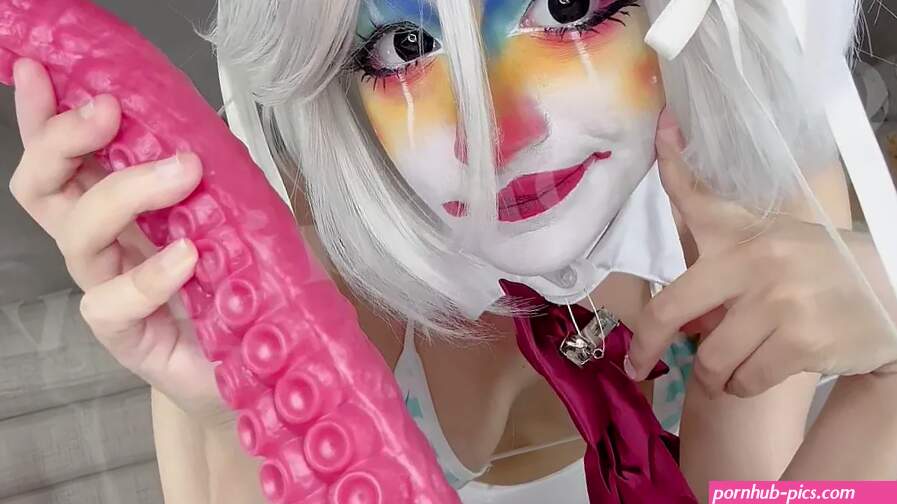 Clown girl performing anal masturbation