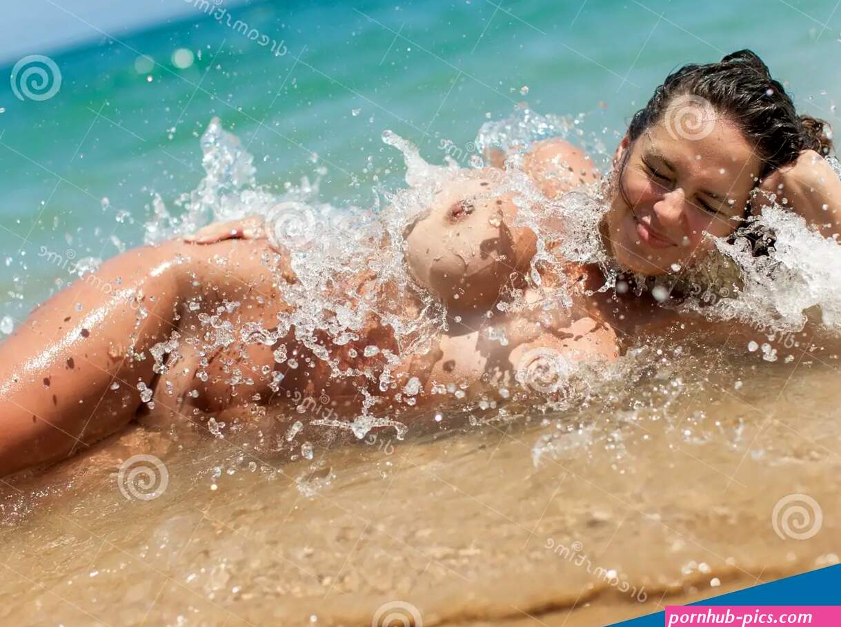 Skinny-Dipping. Naked Woman Lying in Line of Surf Stock Image