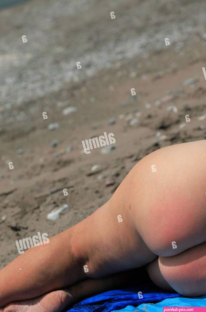 Naked woman enjoying time on the Beach in the nude Dodecanese islands Southern Aegean Greece Stock Photo