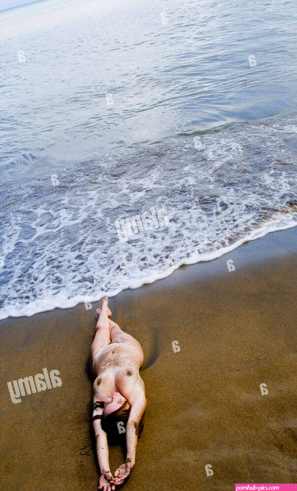 Naked woman lying on the beach elevated view Stock Photo