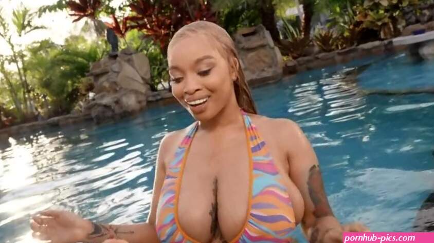 Full-bosomed ebony babe is getting fucked by the pool