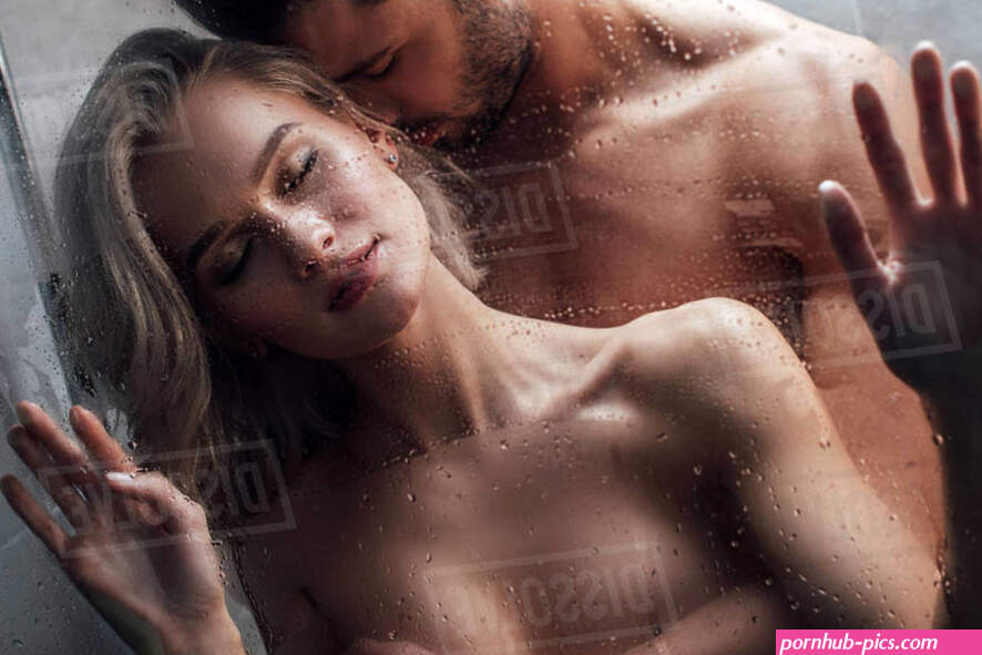 Handsome man passionately embracing attractive woman in shower