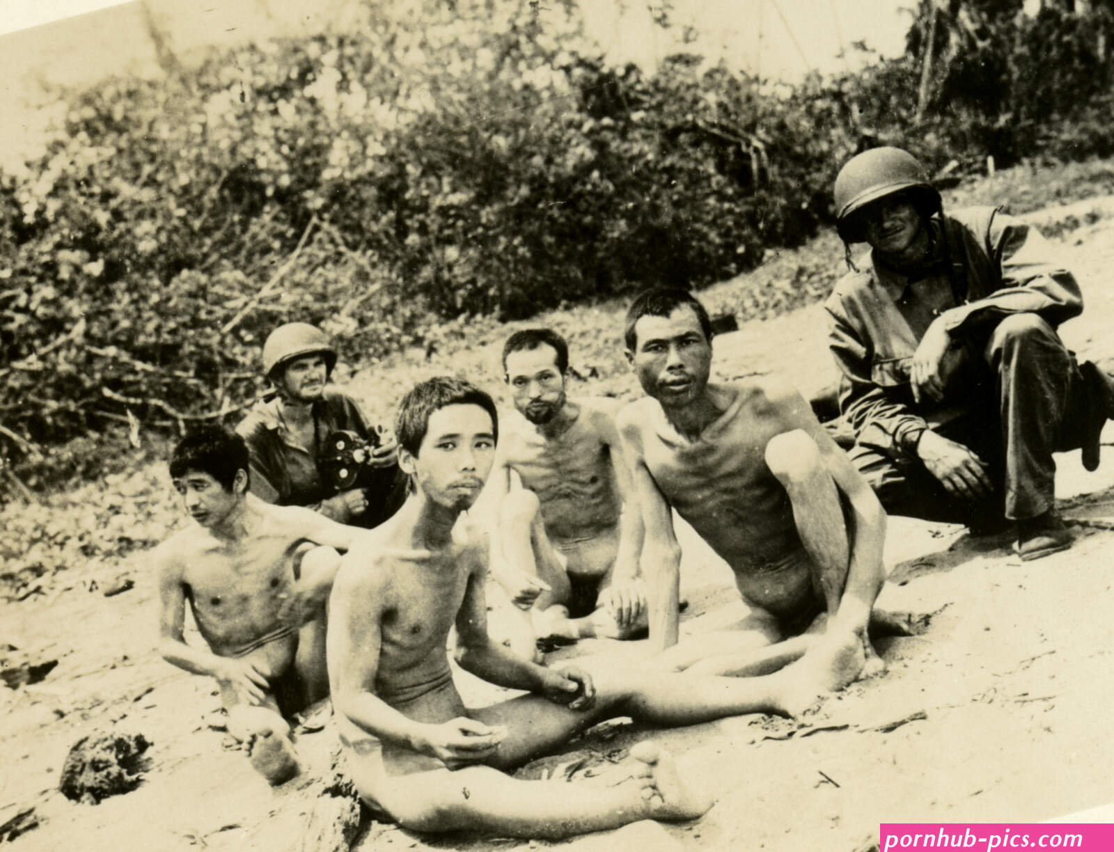 Naked Japanese POWs guarded over by two American GIs 1945