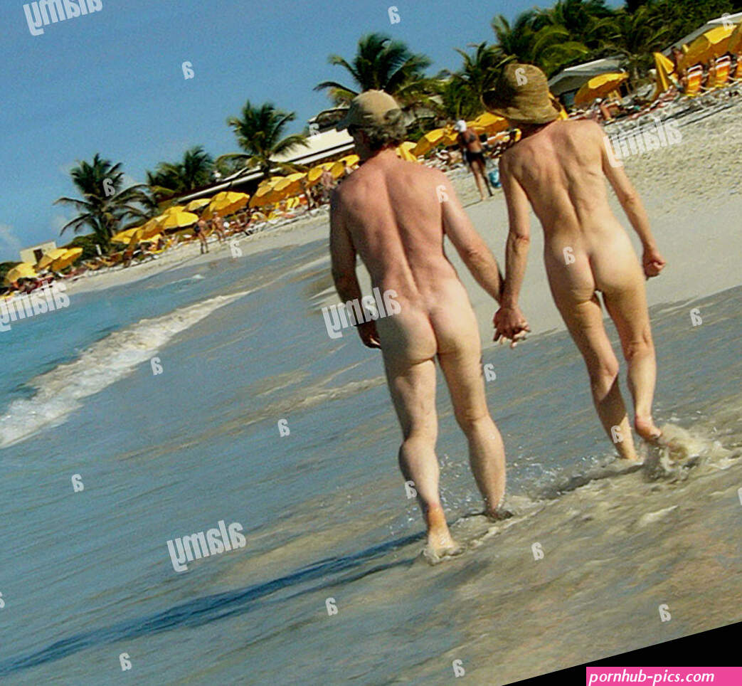 Couple walking on nude beach Stock Photo