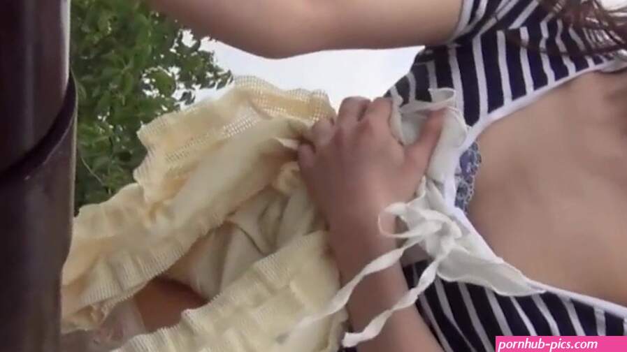 Asian Babe Pees While Rubbing Her Pussy Onto The Railings