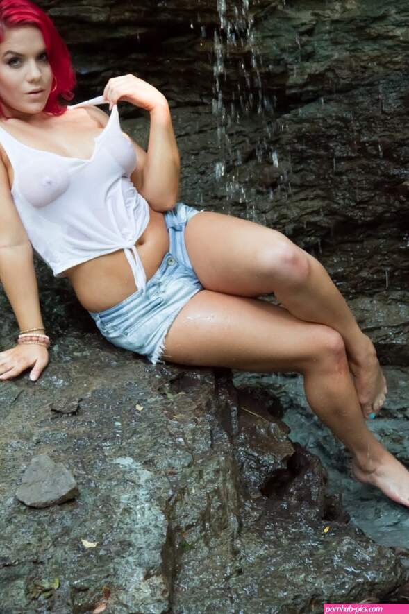 Harley strips naked under a waterfall.