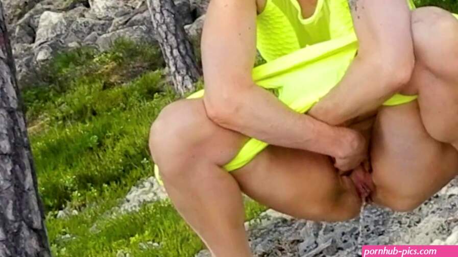 Blonde hot MILF peeing outdoors in the forest view from front in slow motion