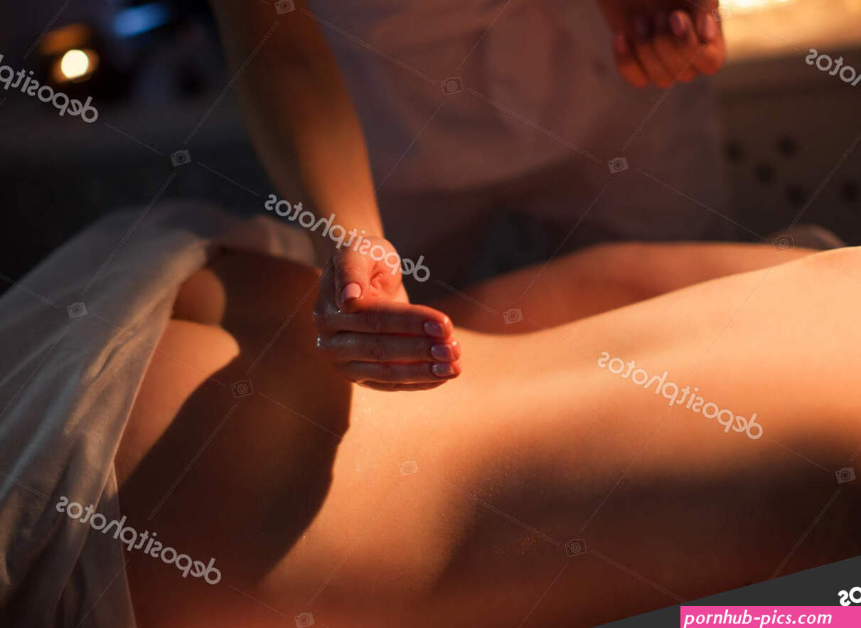 Spa therapy. The naked woman is receiving the oil massage in dark room. Beauty salon location. Stock Photo imidglviv. 187659930