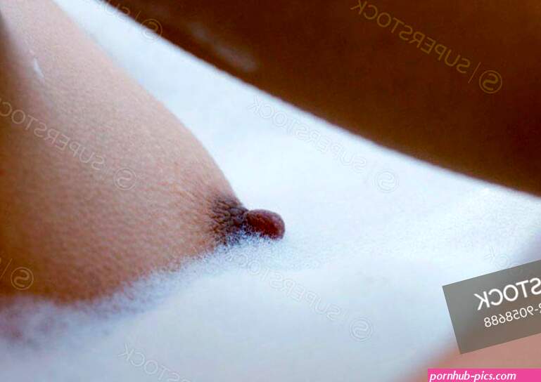 Womans breast in bubble bath
