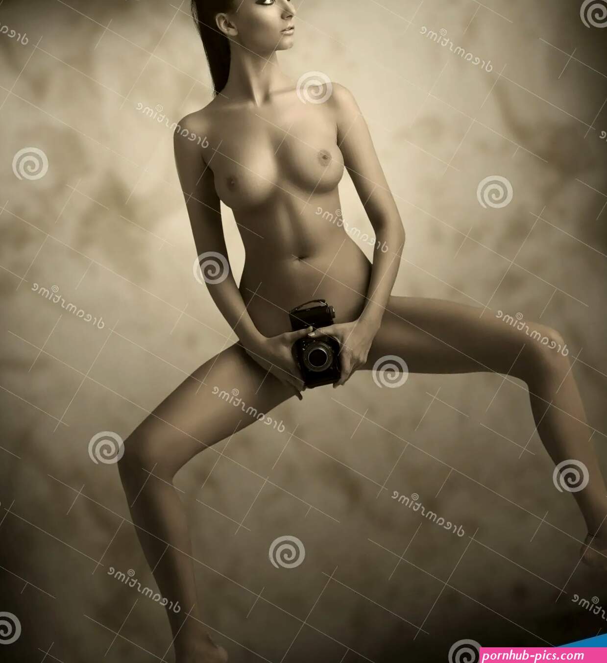 Naked Girl with Vintage Camera Looks at Right Stock Image