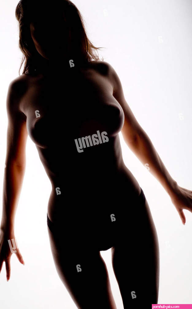 Silhouette naked girl moves with sensuality in studio with white background Stock Photo