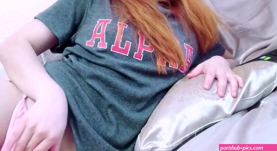 Redhead teen girl watching porn ad masturbating! This hot teen was so horny she took off her pink panties and began to finger her shaved pussy in her bedroom while watching gay