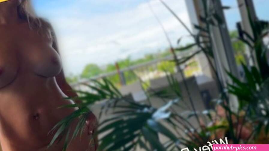 Hot MILF strips NUDE on public balcony