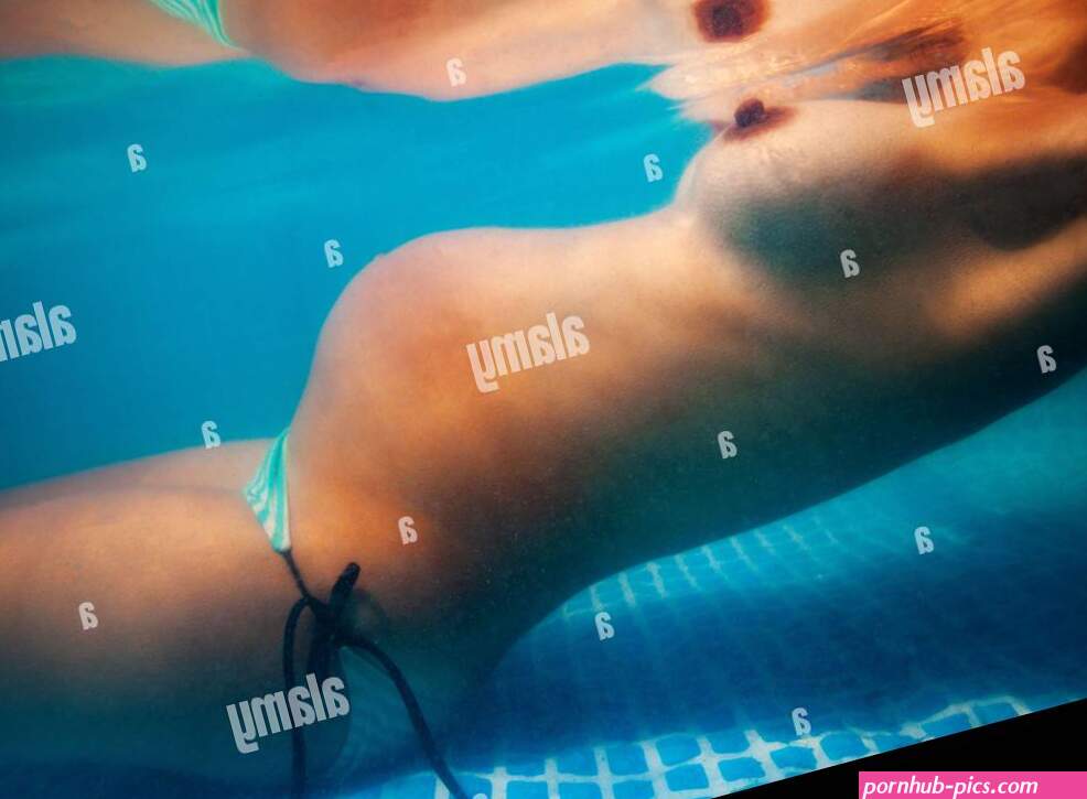 Woman with naked breast underwater in the pool Stock Photo
