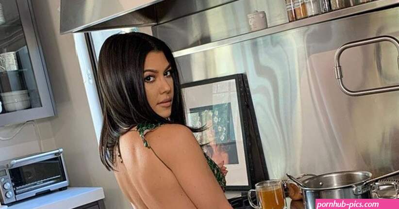 Kourtney Kardashian Shows Off Some Booty Cleavage in Emerald Sequin Gown While Cooking in the Kitchen