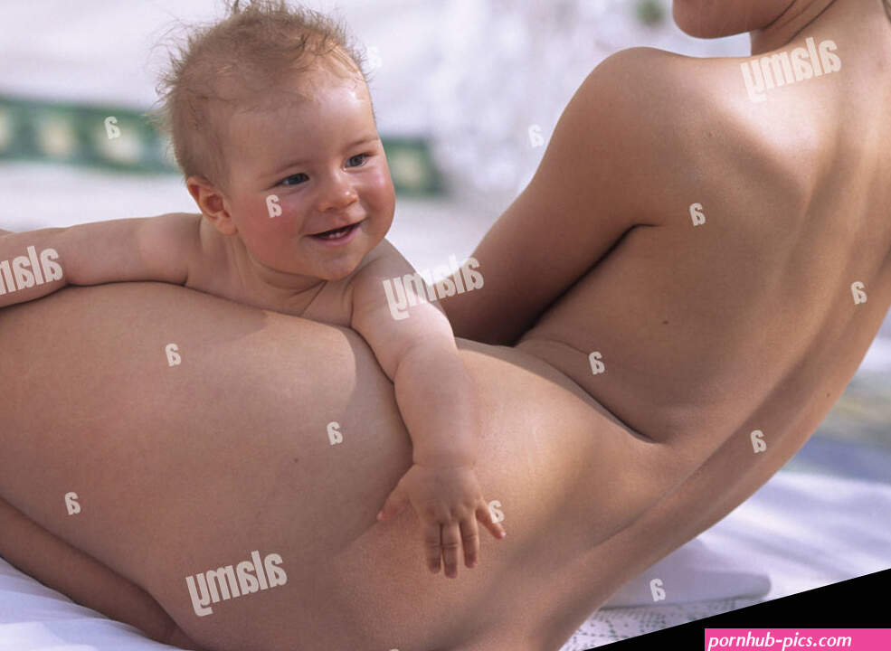Mother baby in the nude woman lie back view summer child small 5 months infant smile shell contact together happily happily curled inside conception childhood love suture security affection care allowance closeness