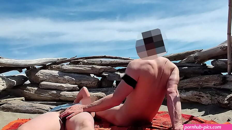 Fingering wet pussy on public beach and gets caught and interrupted by voyeur