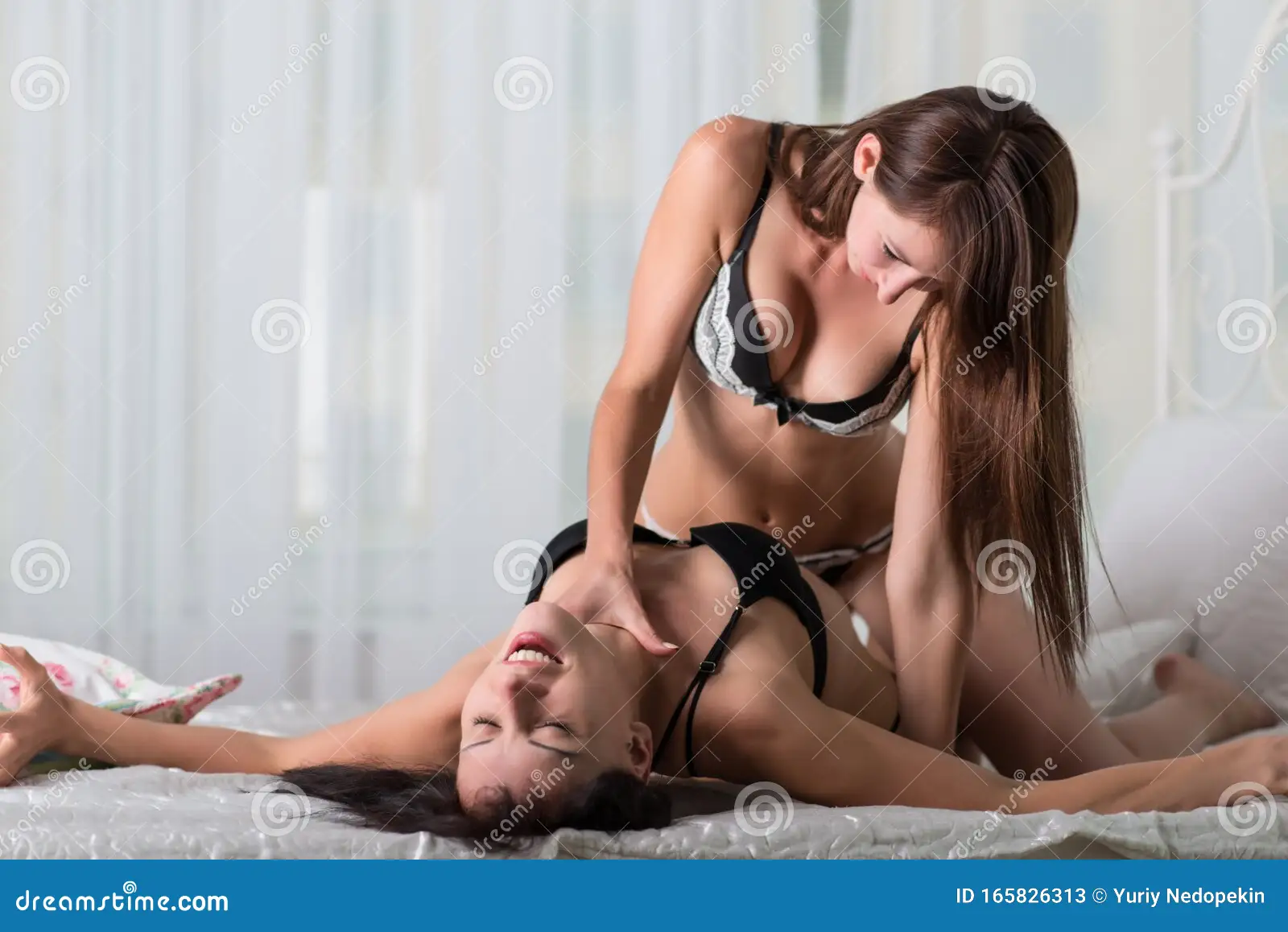 Two Lesbian Girls Practicing Games in Bed Ober White Background Stock Image