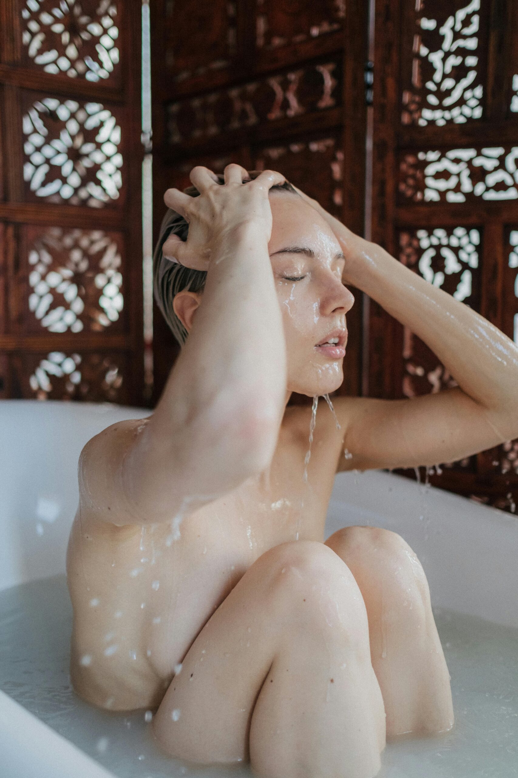 Topless Woman in Bathtub With Water Free Stock Photo