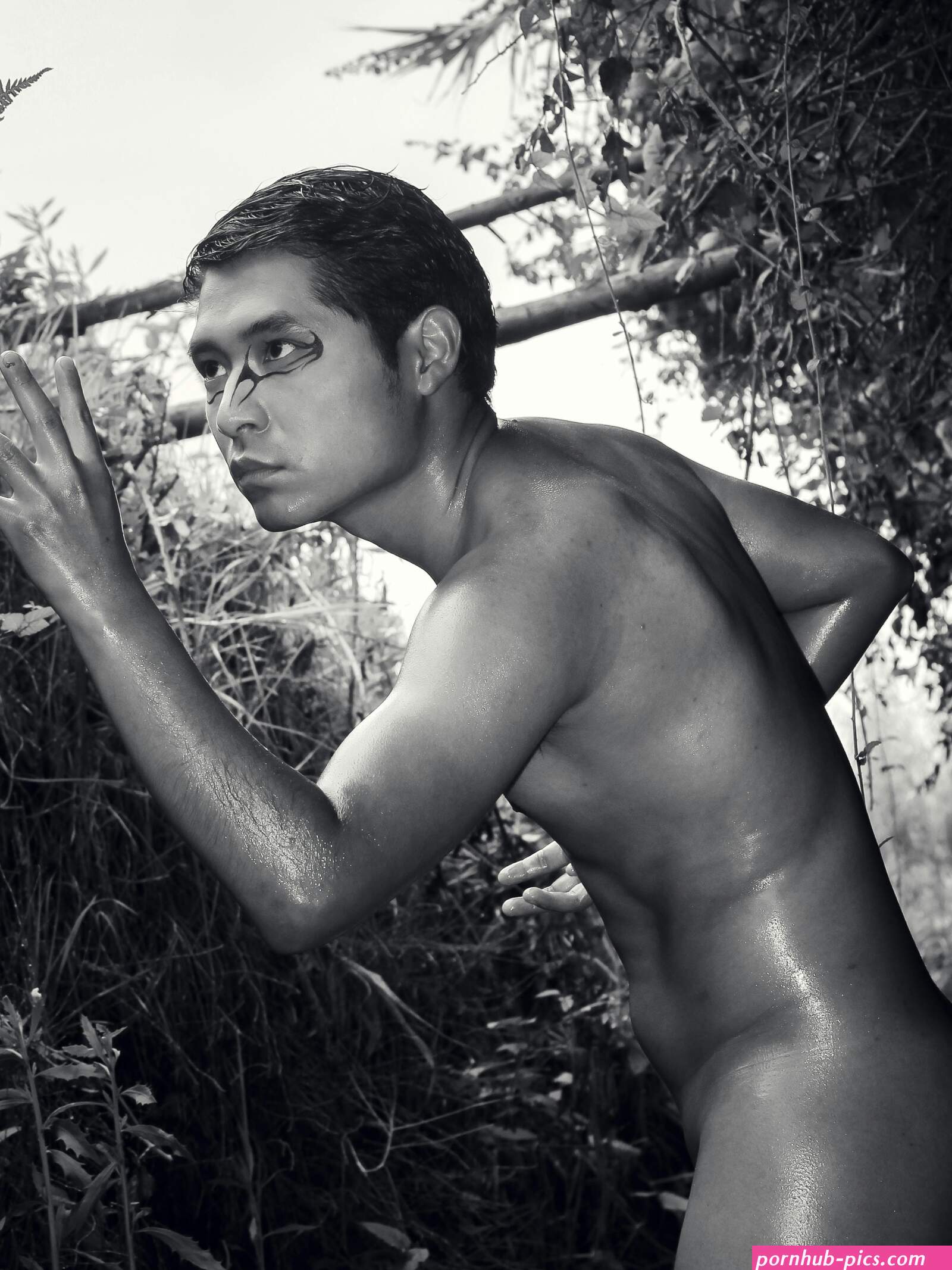 Naked Man Posing Among Plants Free Stock Photo